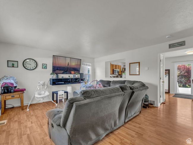 Living area featuring light wood-style flooring and baseboards | Image 5