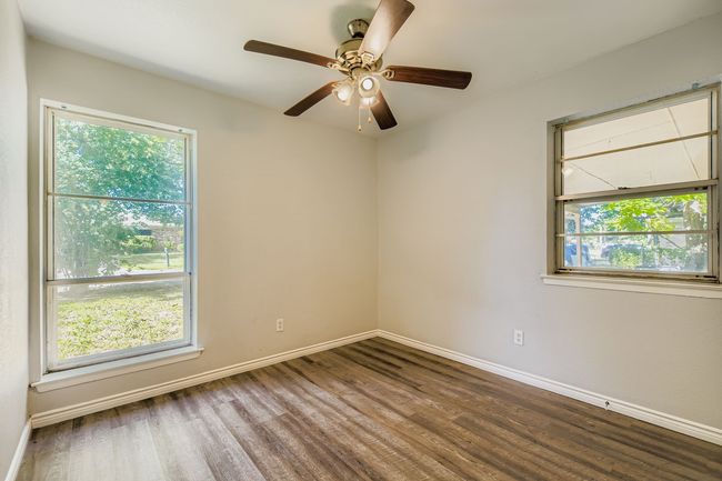 Spare room with wood finished floors and ceiling fan | Image 7