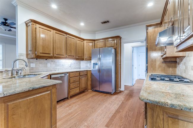 Kitchen featuring Granite counters all Stainless steel appliances Bosh Dishwasher, Frigidaire Refrigerator, Gas cook-top. built in Oven and Microwave. Insta Hot water source | Image 11