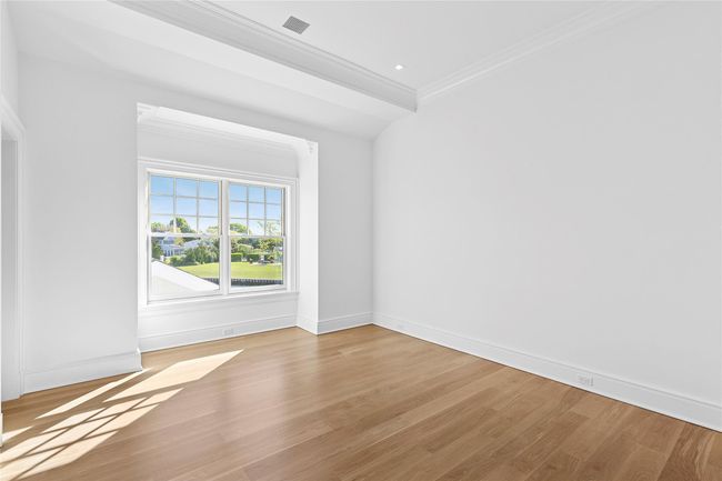 Spare room with crown molding, light wood-style flooring, and baseboards | Image 33