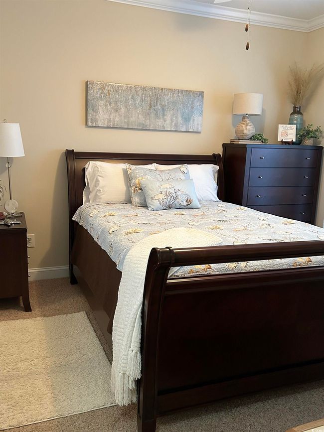 Bedroom featuring ornamental molding, carpet flooring, and baseboards | Image 16