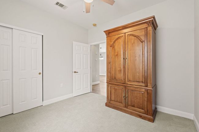 Unfurnished bedroom with a closet, baseboards, visible vents, and light colored carpet | Image 27