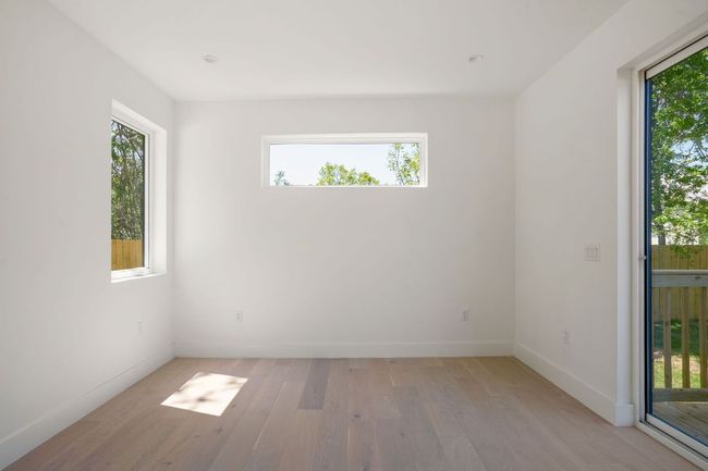 Spare room with baseboards, light wood-type flooring, and a healthy amount of sunlight | Image 11