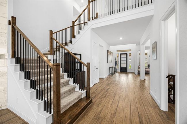 These beautiful stairs lead us to 3 bedrooms, 2 baths, game room and media room. | Image 16