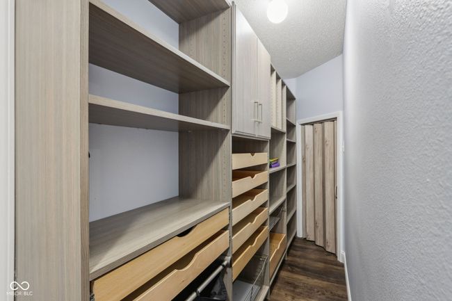 walk in closet featuring dark wood-style floors | Image 48