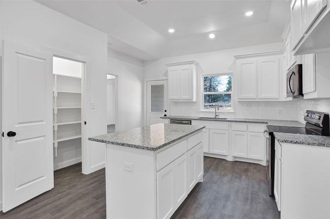 Kitchen with stainless steel appliances, a sink, dark wood finished floors, tasteful backsplash, and recessed lighting | Image 5