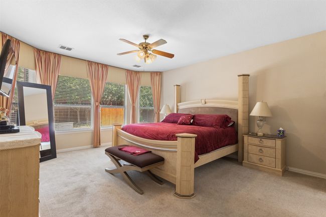Bedroom with light carpet, baseboards, and ceiling fan | Image 16