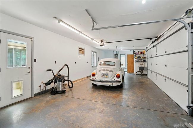 inside rear garage, door to back paver patio | Image 75