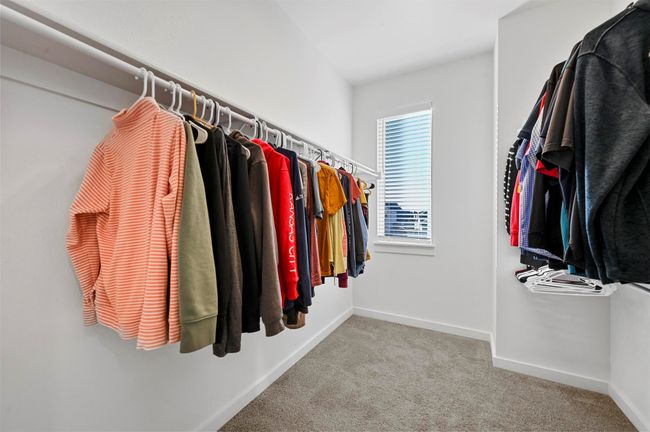 Spacious closet featuring light colored carpet | Image 24