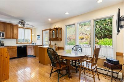 You will love this open kitchen/dining area with beautiful hardwood floors. | Image 2