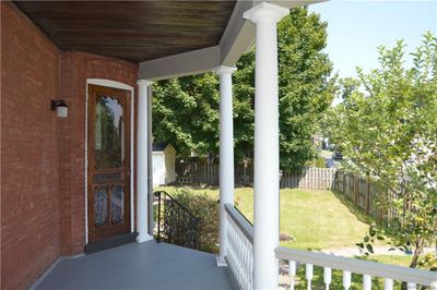 View of exterior entry featuring covered porch and a yard | Image 2