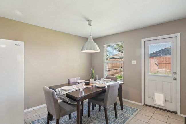 Dining room with baseboards and light tile patterned floors | Image 10