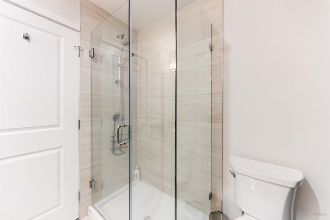 Bathroom featuring toilet and a stall shower | Image 28