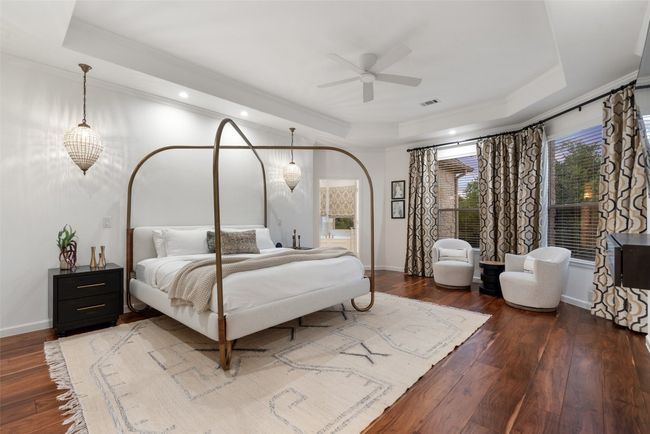 Bedroom featuring a raised ceiling, hardwood / wood-style flooring, and baseboards | Image 12