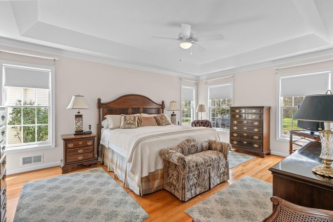 Primary bedroom suite with vaulted ceiling is generous and elegant. | Image 10