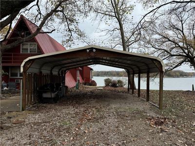 View of parking / parking lot with a carport and a water view | Image 2