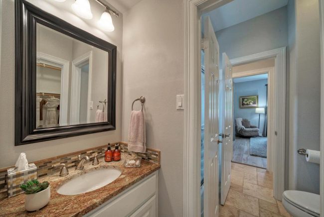 Bathroom with toilet, vanity, and stone tile flooring | Image 23