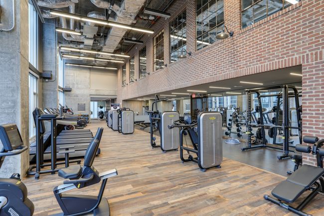 This state-of-the-art main fitness center features Technogym equipment, reclaimed wood floors, exposed brick, and floor-to-ceiling windows. | Image 52
