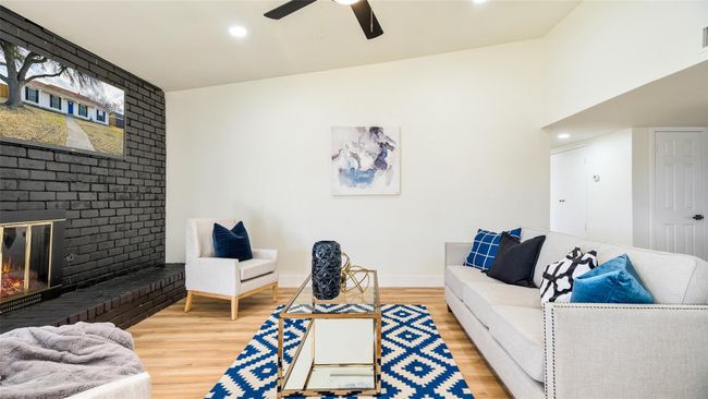 Living room with baseboards, recessed lighting, a fireplace, a ceiling fan, and wood finished floors | Image 7