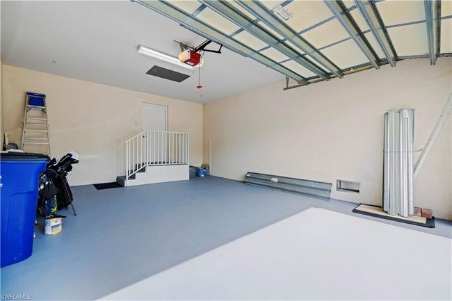 Garage featuring newly painted floor and garage door opener | Image 26