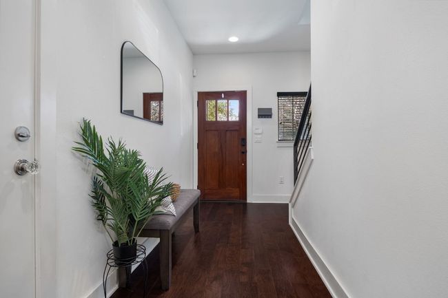 Doorway featuring dark wood-type flooring and baseboards | Image 5