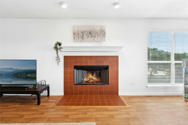 Detailed view of wood finished floors and a tile fireplace | Image 18