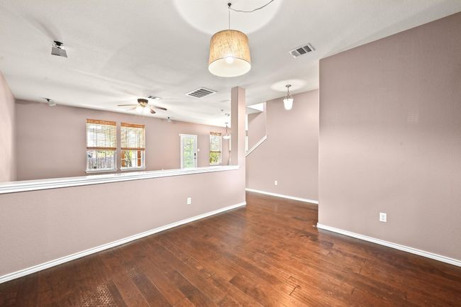 Unfurnished room featuring hardwood / wood-style floors and a ceiling fan | Image 7