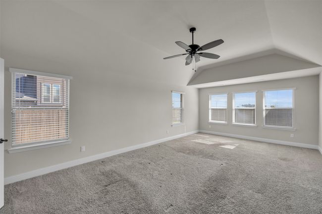 Large primary bedroom featuring ceiling fan and an abundace of light | Image 21