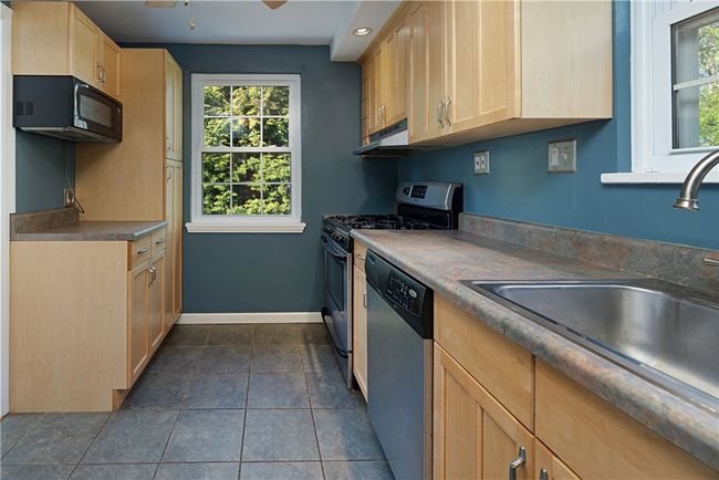 Kitchen: Lots of cabinets & a pantry. | Image 12
