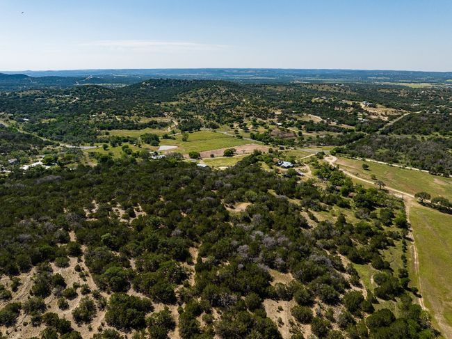 Aerial view of property's location with a heavily wooded area | Image 37