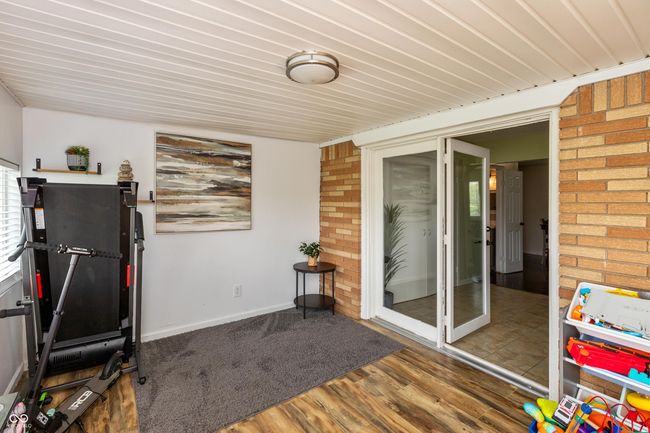 exercise room with brick wall, wood finished floors, and wooden ceiling | Image 18