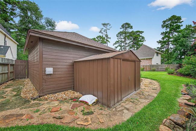 Nestled discreetly to the side, the backyard storage shed provides extra space for tools, hobbies, or seasonal décor. | Image 48