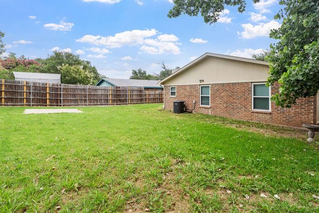 Back of house with french doors, a patio, brick siding, and a fenced backyard | Image 32