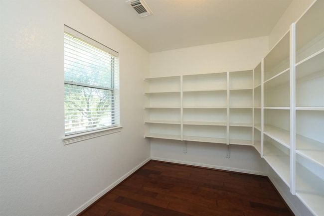 This 10 x 8 room can be an office or gaming area with raised storage shelves and is entered from the gameroom. Great backyard views. | Image 24