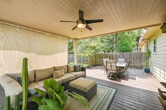 Deck featuring an outdoor hangout area, outdoor dining space, a fenced backyard, and a ceiling fan | Image 28