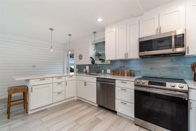 Kitchen # 1 - The full-size kitchen features shaker cabinets, quartz countertops, and a walk-in pantry. | Image 3