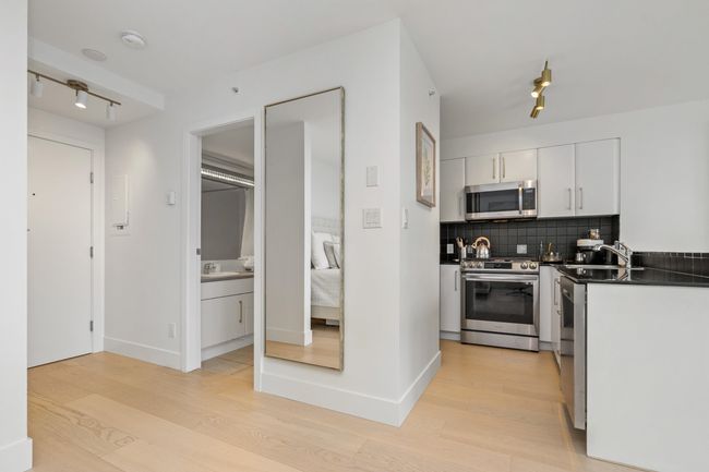 Kitchen featuring dark countertops, dishwasher, a wealth of natural light, and light wood-style floors | Image 8