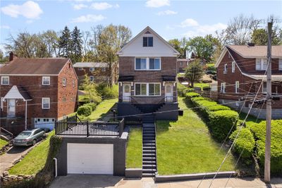 Three units up and down with a detached income garage and coin op laundry plus off street parking in rear accessed via Outlook St. | Image 1