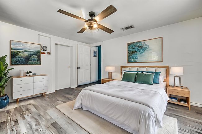 Bedroom featuring wood finished floors and a ceiling fan | Image 4