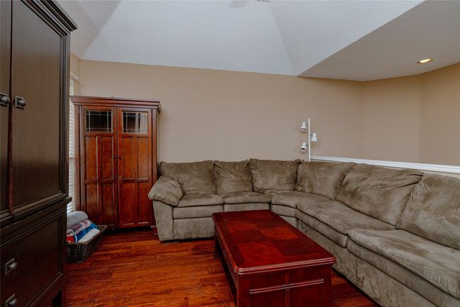Living area with dark wood-style flooring and recessed lighting | Image 20