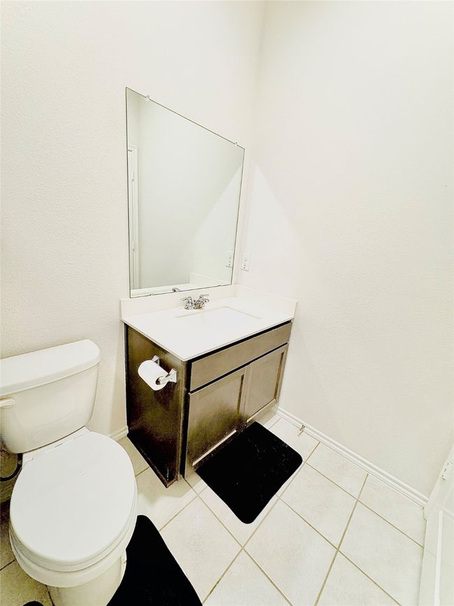 Bathroom featuring vanity, baseboards, toilet, and tile patterned flooring | Image 22