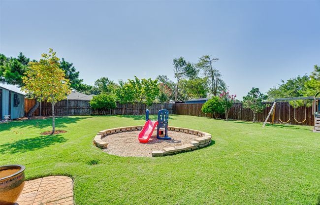 Fenced backyard with a playground | Image 32