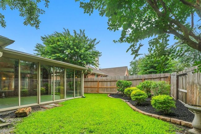 Beautifully maintained backyard offers a lush lawn, mature trees, and well-designed landscaping that enhances the outdoor ambiance. It’s an ideal space for enjoying quiet mornings, weekend gardening, or evening gatherings. | Image 37
