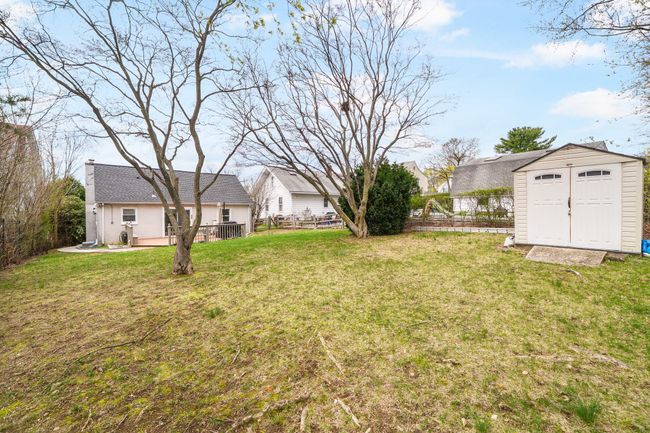 View of yard featuring fence, an outbuilding, and a shed | Image 33