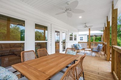 Wooden deck with ceiling fan, an outdoor hangout area, and french doors | Image 3