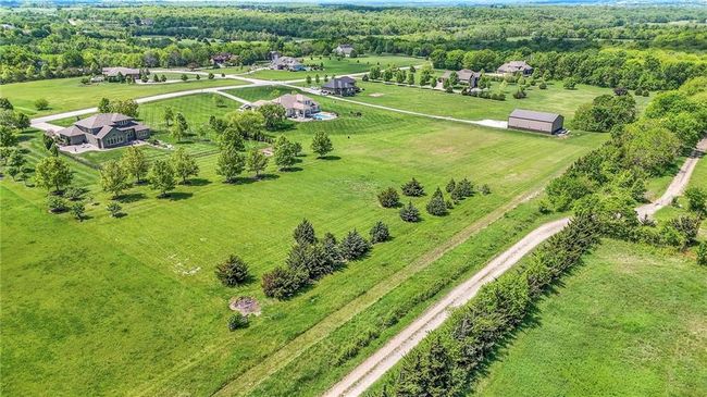Aerial view of walking/horse trail behind house to private community lake | Image 66