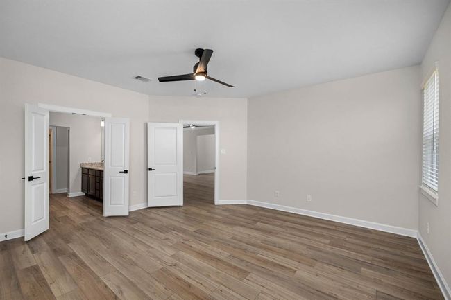 The primary bedroom with en-suite bathroom is a sanctuary of elegant sophistication. Refined finishes, and a tranquil color palette create a serene and inviting atmosphere perfect for rest and relaxation. | Image 4