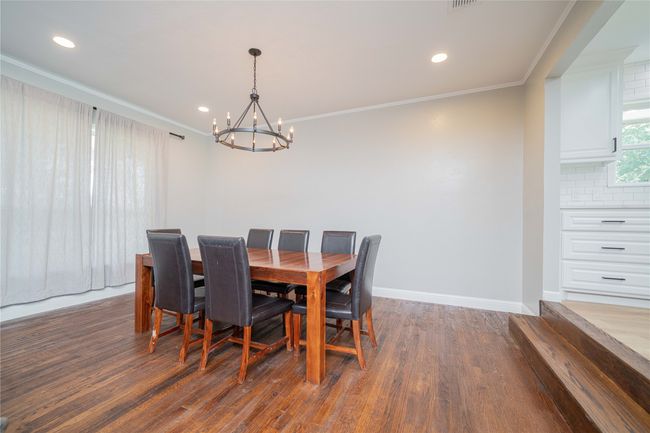 Dining space with a chandelier, crown molding, wood finished floors, and recessed lighting | Image 11