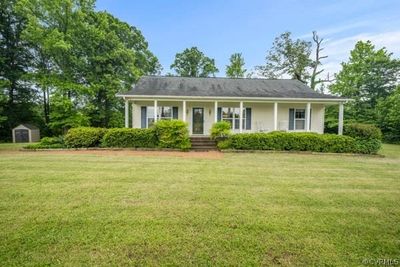 View of front of property featuring a front lawn and a porch | Image 1