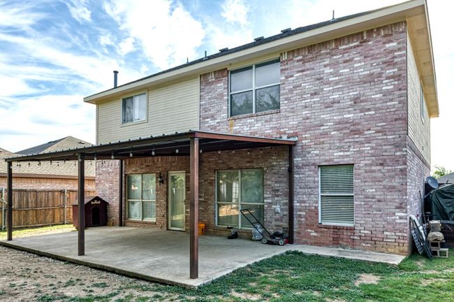 Rear view of property featuring a patio and brick siding | Image 15